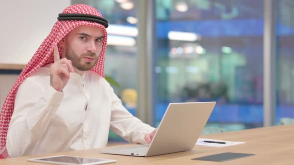 Serious Arab Businessman with Laptop Saying No with Finger Sign