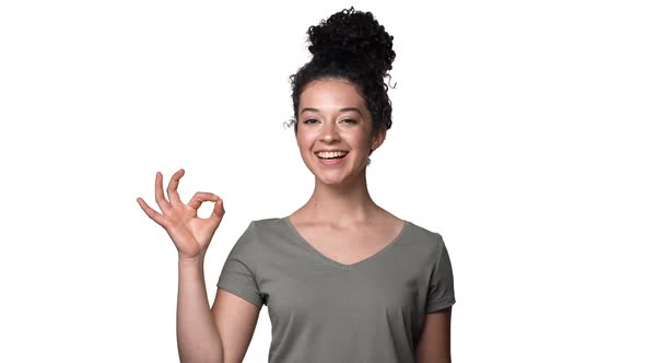 Portrait of Happy Woman 20s in Casual Clothing Smiling and Showing Alright Symbol with Fingers