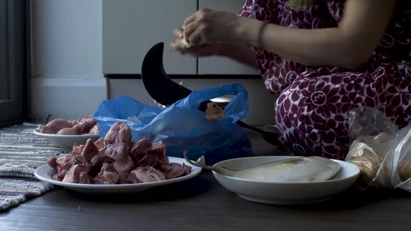 Close-up hands of women slicing  potatoes Using Pahsul or Boti. Locked Off