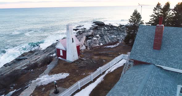 Tourist walking by the bedrock of Grindel Point Light Islesboro Maine United States