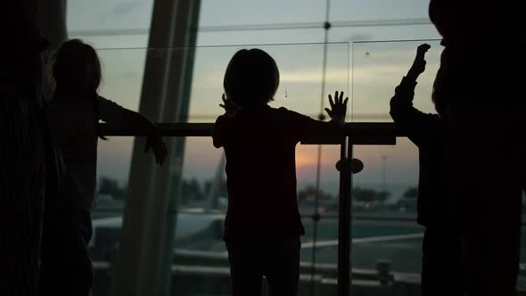 Children Standing Near the Window at the Airport