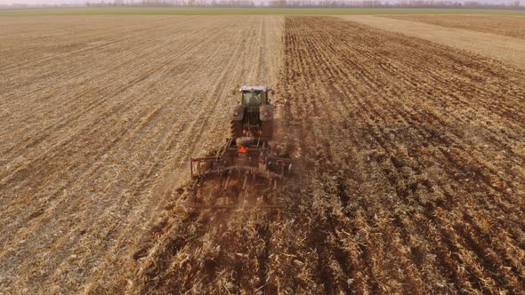 Tractor Plowing Field After Harvesting