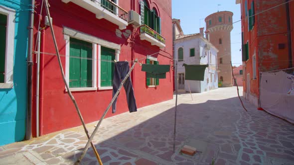 Clothes Drying on Clothesline Between Colorful Houses Walls