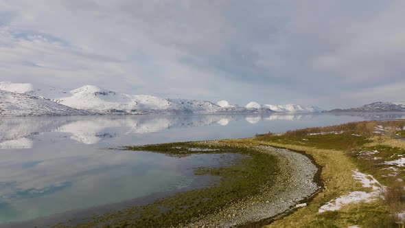 Cotton snow mountains by the sea. Magical landscape in Norway. Cinematic. Aerial