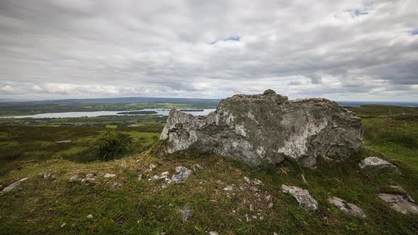 Time lapse of rural and remote landscape of grass, trees and rocks during the day in hills of Carrow