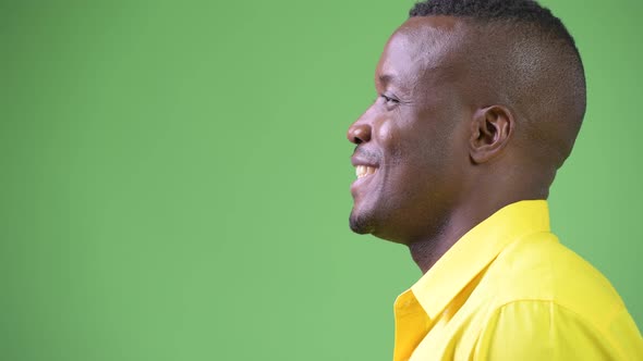 Profile View of Young Happy African Businessman Wearing Yellow Shirt