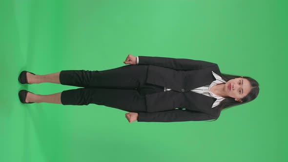 Full Body Of A Terrible Asian Business Woman Looking At Camera In The Green Screen Studio