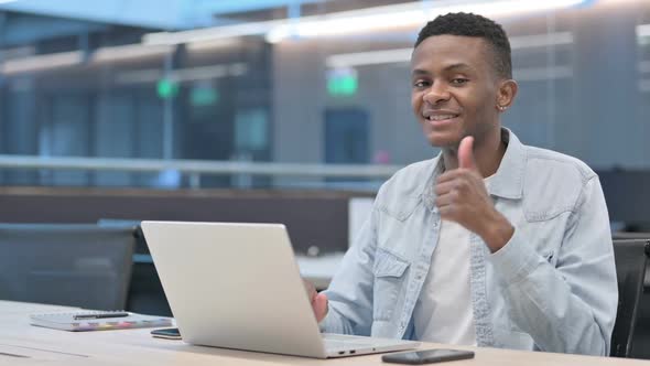 Thumbs Up by African Man with Laptop at Work