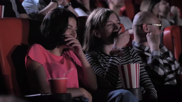 Teenage Girls Shaking with Laughter During Comedy