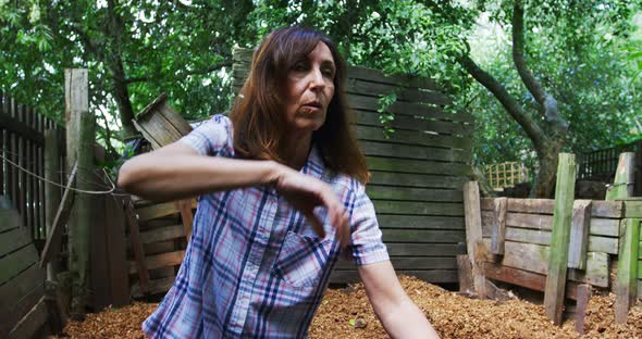 Mature woman using gardening fork in the garden 4k