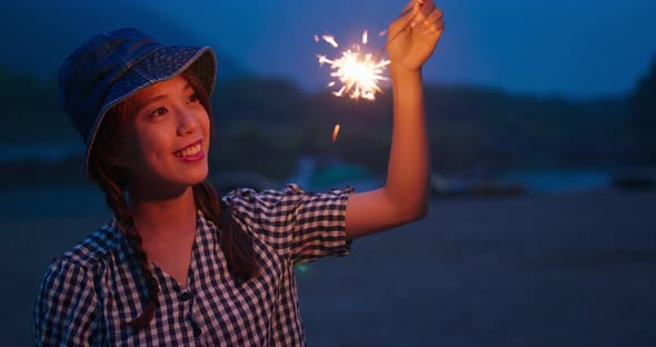 Woman play with sparklers in the summer time at outdoor