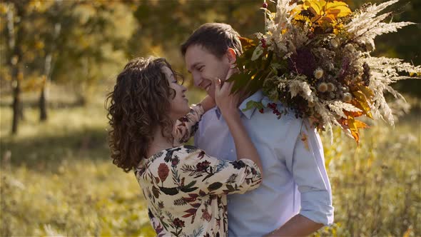 Young Couple in Love Walking on Meadow in Summer - Togetherness Concept