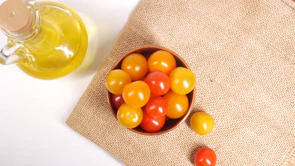 Colorful Cherry Tomato in a Bowl and Olive Oil on Table