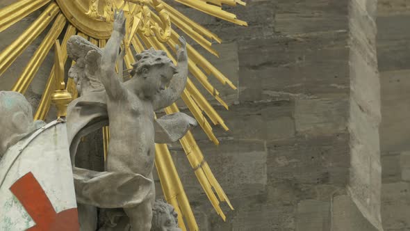 Child sculpture near a golden decoration