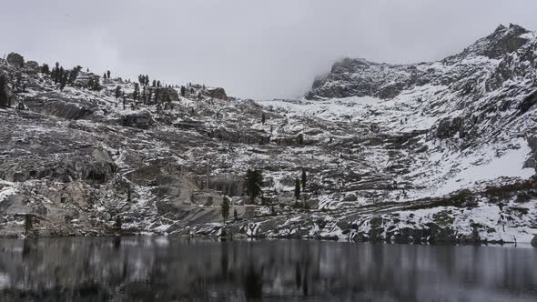 Thick, Low Clouds Pass Over Alpine Peak and Lake, Timelapse