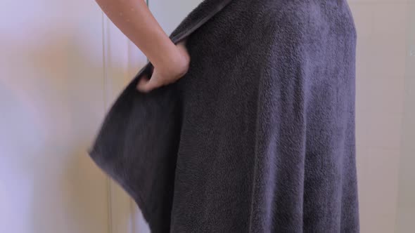 Attractive woman drying off aster taking her morning shower.