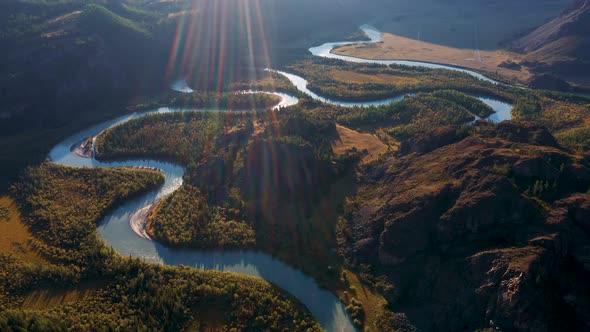 River Bed Meanders Horseshoe In Valley Of Mountain Canyon With Rocks Sunset Rays