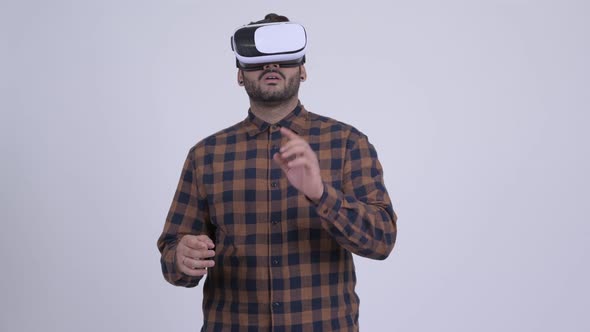 Young Bearded Indian Hipster Man Using Virtual Reality Headset