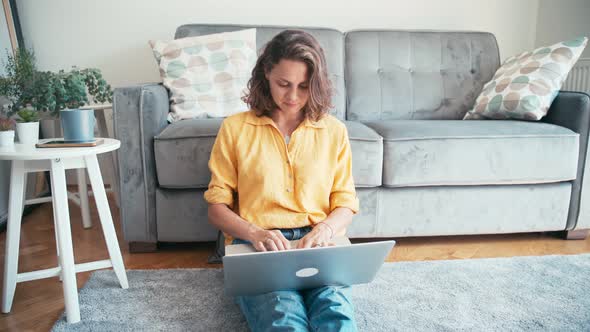 Young Serious Woman Remote Employee Working on Her Laptop at Home