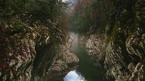 Flying Over a River Through a Narrow Canyon with White Rocks Sochi