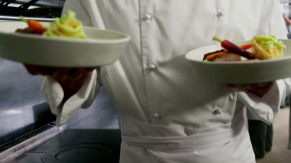 Happy chef presenting his food plates