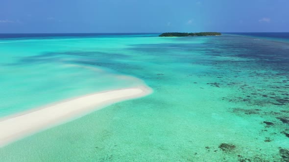 Aerial flying over seascape of beautiful tourist beach holiday by turquoise sea with white sand back