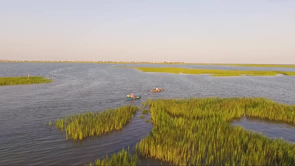 Drone tracking kayakers in Wooland Creek near Murrells Inlet SC at sunset