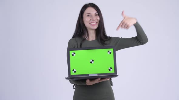 Happy Young Beautiful Woman Showing Laptop and Giving Thumbs Up