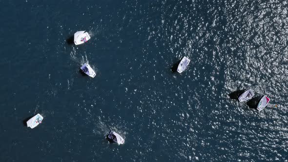 Top down view of regatta of small boats on lake