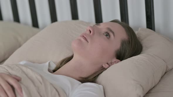 Young Woman with Insomnia Lying in Bed at Home