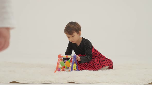 Toddler Girl Wearing Diaper and Her Sister Playing with Balls