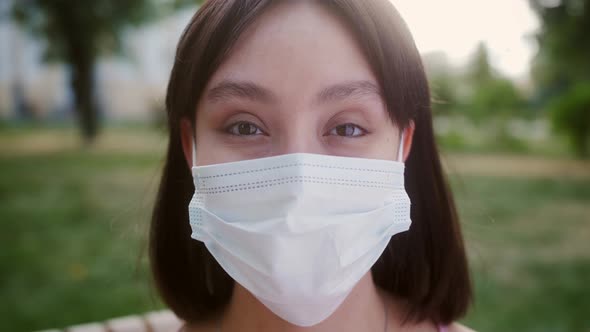 Mixed Race Female Looking at the Camera Taking Off Medical Protective Mask and Smiling