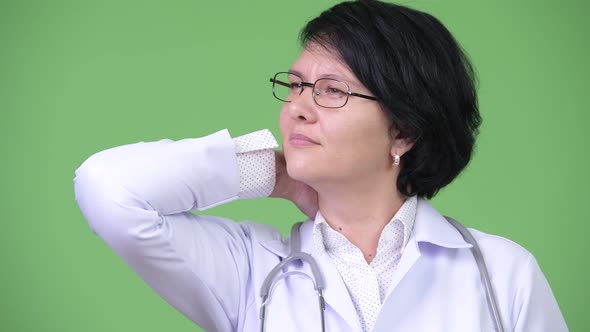 Stressed Woman Doctor with Short Hair Having Neck Pain