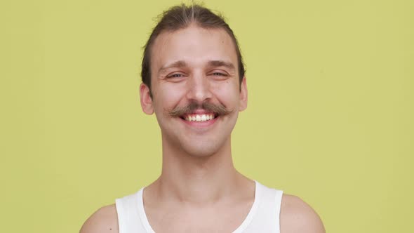 Cool Bright Guy with Mustaches Smiling Over Yellow Background Closeup