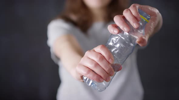 Girl Crumpling Plastic Bottle