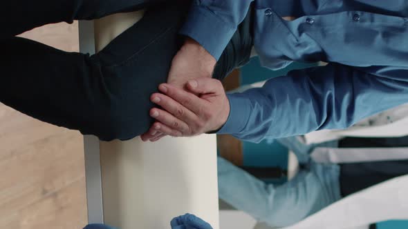 Vertical Video Medical Nurse Comforting Senior Patient at Checkup Consultation