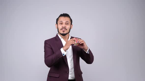 Indian businessman explaining the importance of rubik's cube