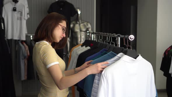 A Young Woman Was Choosing a Shirt in a Store. Clothing Store.