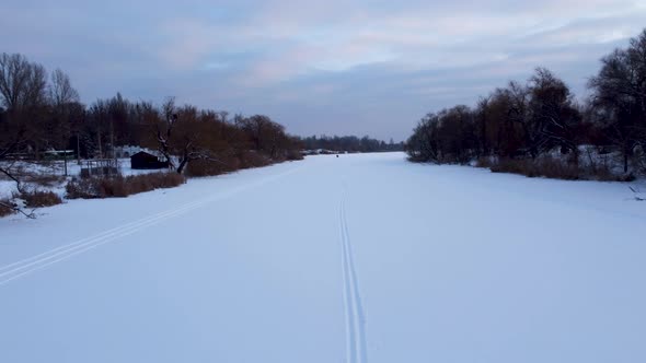 Cross-country wild ski track lines on snowy river