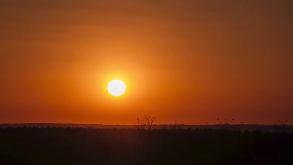 Timelapse Sunset in the Sky Big Bright Yellow Sun Moves Down on the Horizon