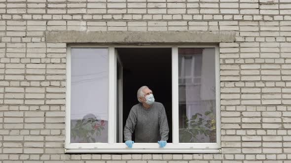 Old Man Grandfather Stay at Window Isolated at Home on Quarantine. Coronavirus alt