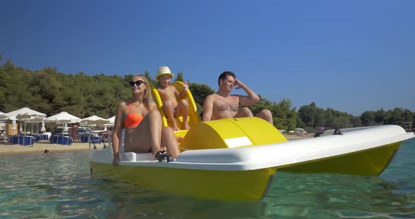 Family with child enjoying pedal boat ride