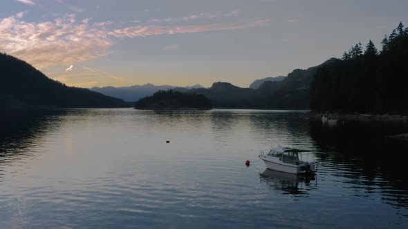 Boat Moored Over The Sechelt Inlet On The Sunshine Coast Near Egmont, Quebec On A Sunset - tracking