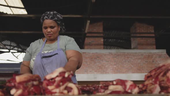African woman looking at the meat