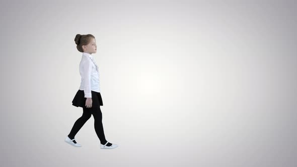 Beautiful Little Girl in Dress Walking By on Gradient Background.