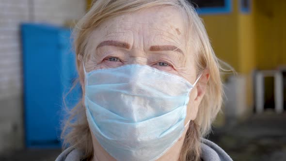 Close Up Portrait Of Old Woman In Medical Mask On Her Face To Protect Virus