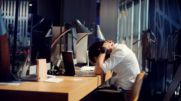 Sad Disappointed Man Sitting On Empty Office. Sad Exhausted Businessman. Annoyed Man.