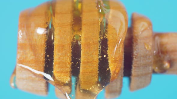 Dripping Honey From a Wooden Spoon Closeup Macro