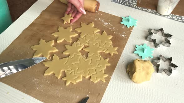 A Woman Works With Snowflake Cookie Dough.