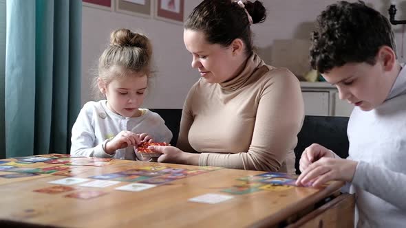 Board educational games with whole family at home in cozy interior